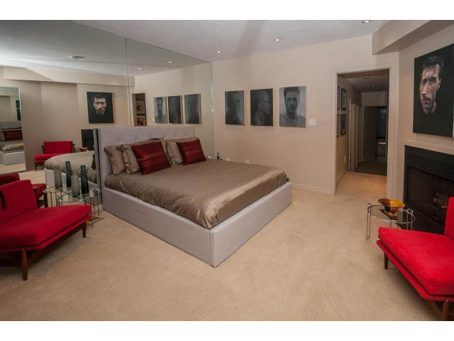 Furnished living room with red couches and modern artwork. - 1882 Whyte Avenue, Vancouver West Side
