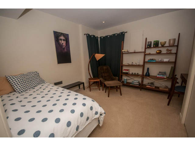 Furnished bedroom with polka dot bedding and wooden furniture. - 1882 Whyte Avenue, Vancouver West Side