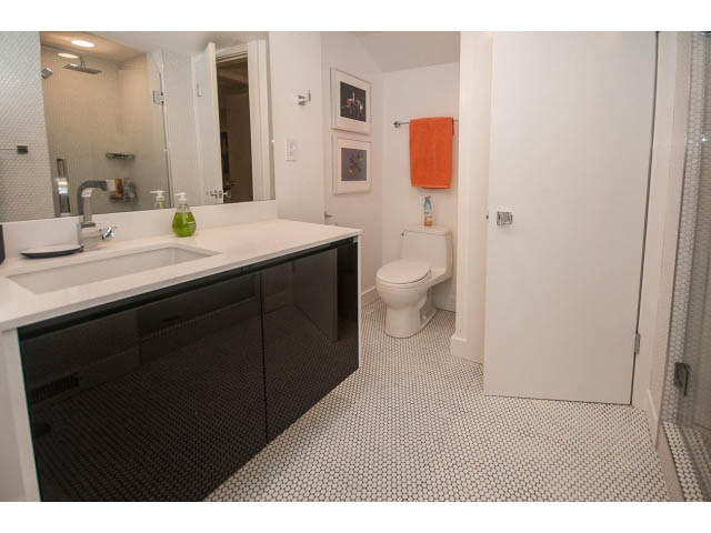 Modern bathroom with hexagonal tile floor and sleek black vanity. - 1882 Whyte Avenue, Vancouver West Side