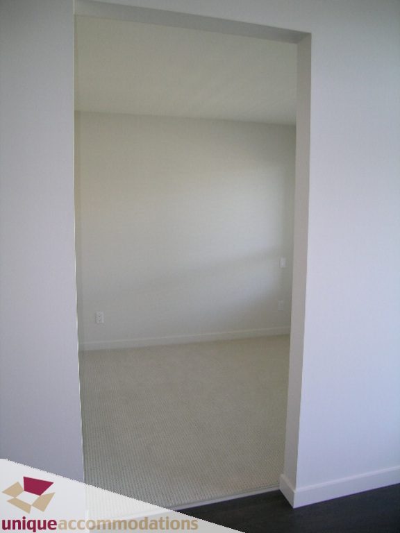 Empty closet with beige carpeting and white walls. - 510 - 1677 Lloyd Avenue, North Vancouver