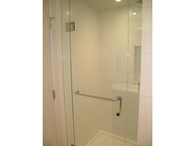 Modern shower with glass doors and sleek fixtures. - 302 - 1677 Lloyd Avenue, North Vancouver