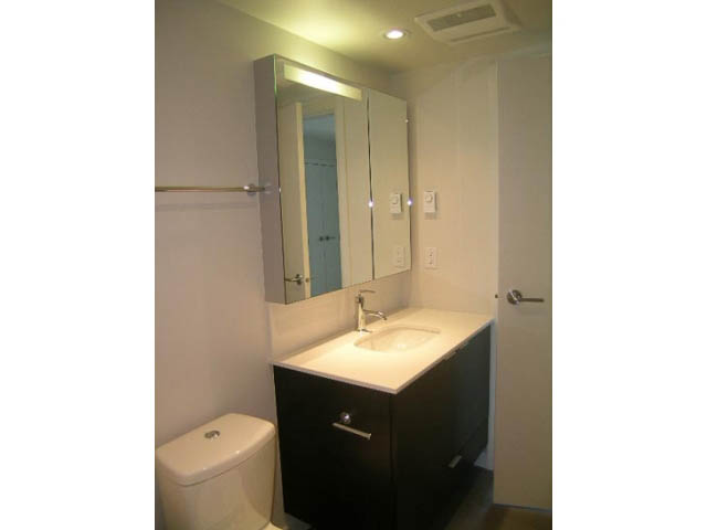 Bright bathroom with white countertops and black cabinet. - 302 - 1677 Lloyd Avenue, North Vancouver