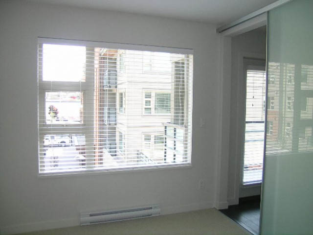 Bright living room with large window and city view. - 302 - 1677 Lloyd Avenue, North Vancouver