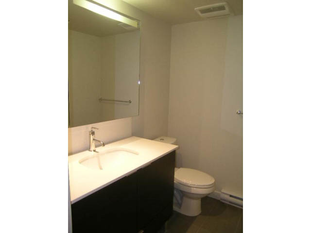 Furnished bathroom with white countertop and toilet. - 302 - 1677 Lloyd Avenue, North Vancouver