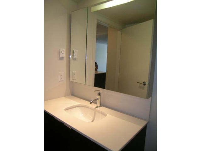 Bright bathroom with white countertop and mirror, modern design. - 302 - 1677 Lloyd Avenue, North Vancouver