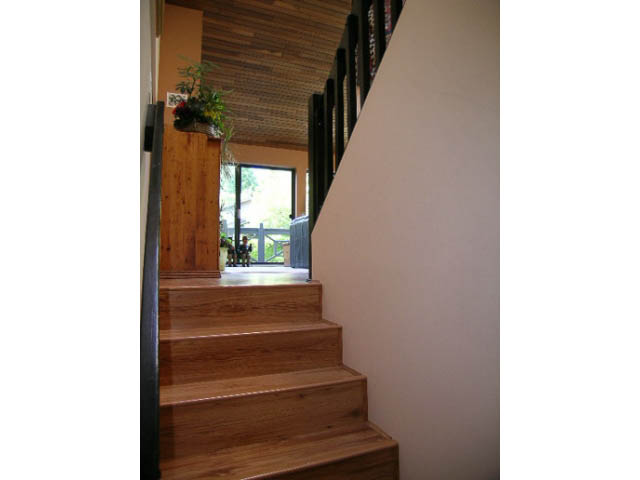 Staircase leading to upper floor with wooden steps and white walls. - 1077 Blue Grouse Way, North Vancouver