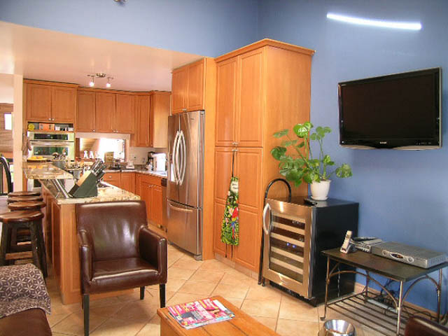 Bright kitchen with granite countertops, stainless steel appliances, and a large island. - 1077 Blue Grouse Way, North Vancouver