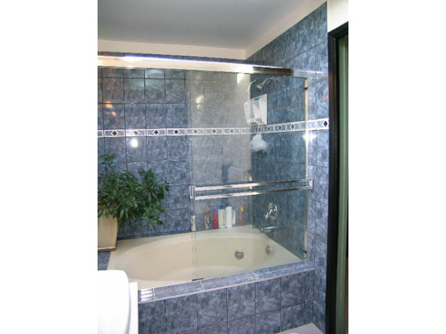 Bathroom with blue tiles and a glass shower enclosure. - 1077 Blue Grouse Way, North Vancouver