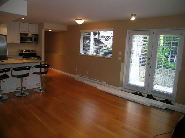 Bright kitchen with hardwood floors and a city view. - 1077 Blue Grouse Way, North Vancouver