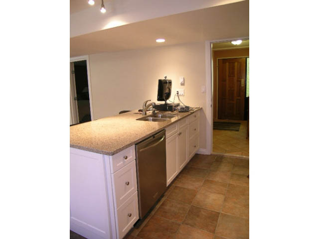Bright kitchen with granite countertops and tiled flooring. - 1077 Blue Grouse Way, North Vancouver