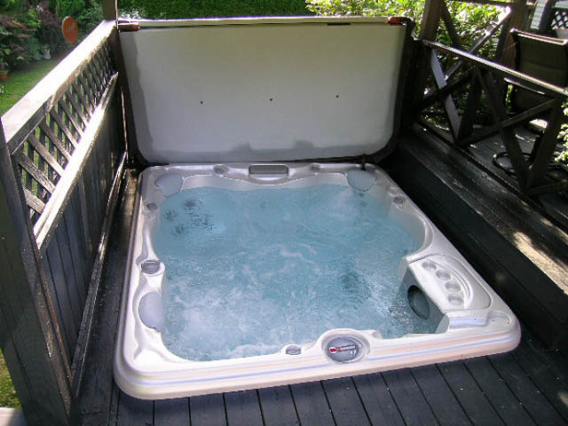 Hot tub on wooden deck with privacy railing. - 1077 Blue Grouse Way, North Vancouver