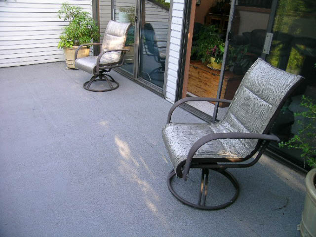 Furnished patio with outdoor seating and sliding glass doors leading to a cozy interior. - 1077 Blue Grouse Way, North Vancouver