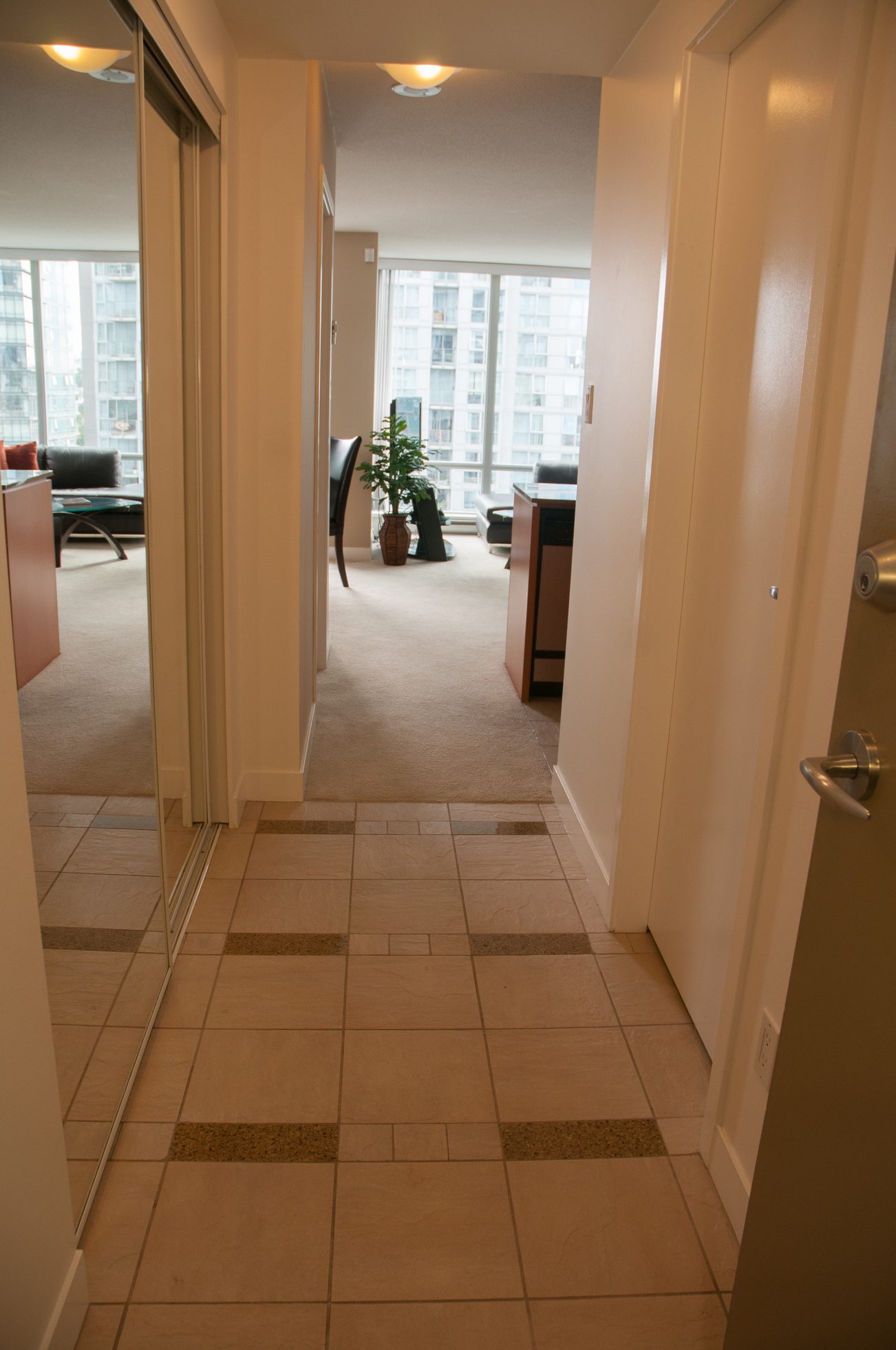 Bright hallway leading to a cozy living area with a city view and modern furnishings. - 1708 - 1438 Richards Street, Vancouver Downtown