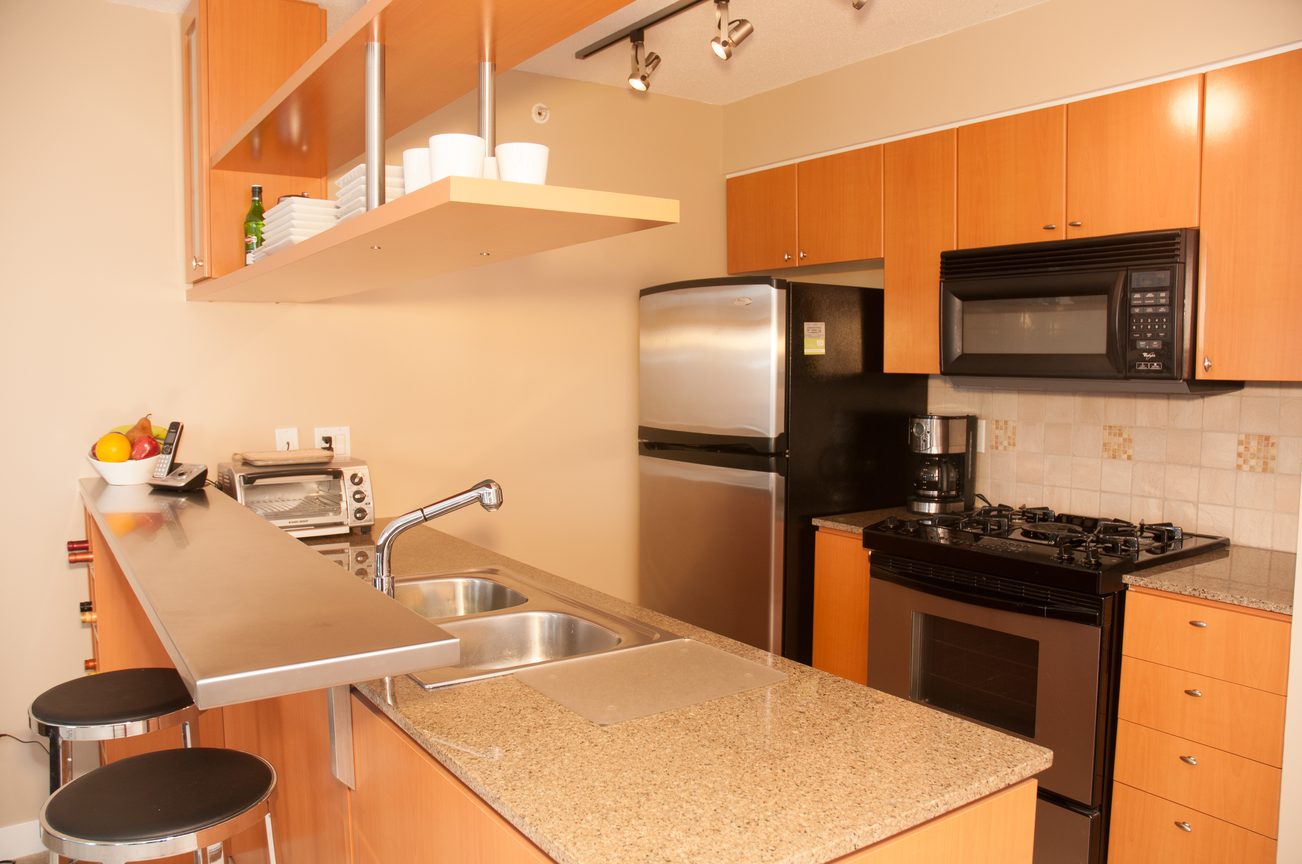 Bright kitchen with granite countertops, stainless steel appliances, and modern cabinetry. - 1708 - 1438 Richards Street, Vancouver Downtown