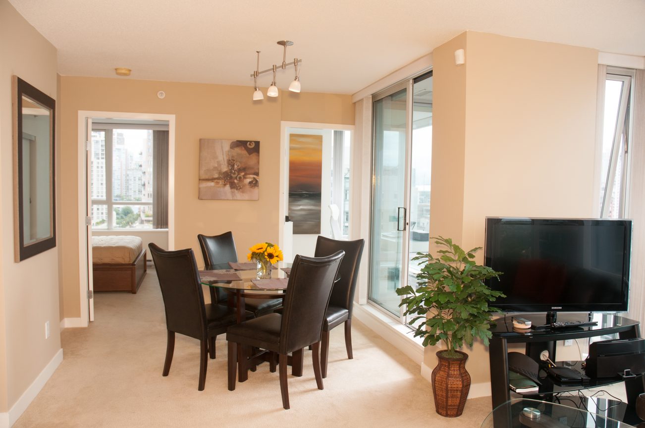 Furnished dining area with city view, modern decor, and sliding glass doors leading to balcony. - 1708 - 1438 Richards Street, Vancouver Downtown