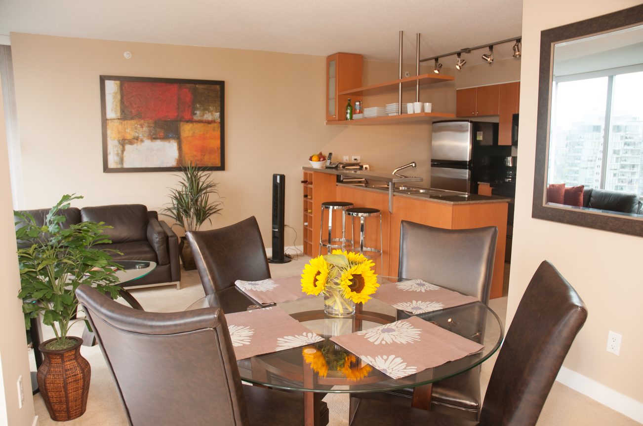Furnished dining area with sunflowers and city view. - 1708 - 1438 Richards Street, Vancouver Downtown