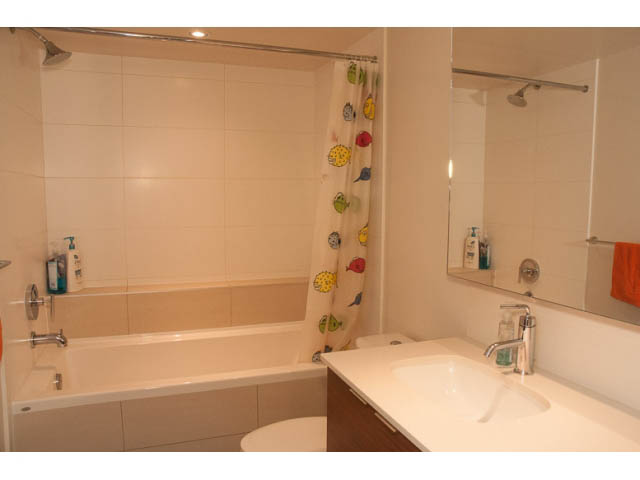 Furnished bathroom with white countertop and modern fixtures. - 215 - 1677 Lloyd Avenue, North Vancouver