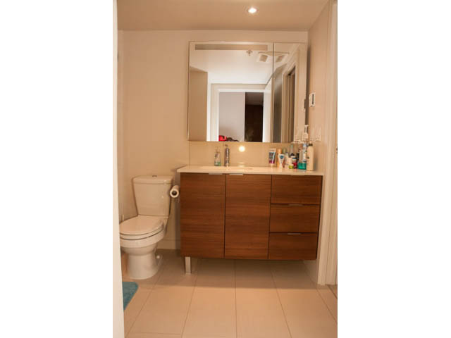 Furnished bathroom with wooden cabinets and modern sink. - 215 - 1677 Lloyd Avenue, North Vancouver