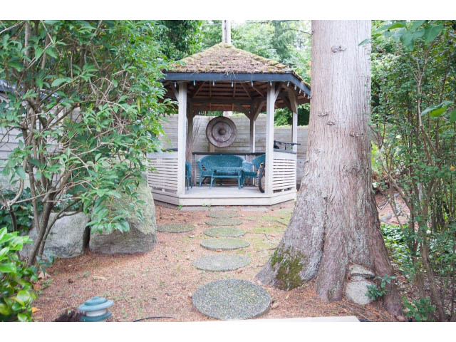 Furnished patio with gazebo, large tree, and stone pathway. - Cottage - 1395  3rd Street, West Vancouver