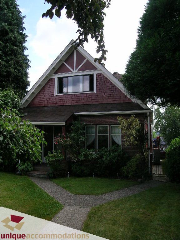 Bright 5-bedroom house with a charming front porch and red brick exterior. - 813 - 5th Street East, North Vancouver