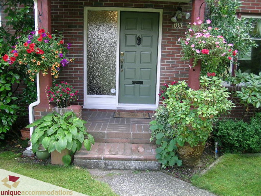 Furnished living room with cozy seating and large windows. - 813 - 5th Street East, North Vancouver