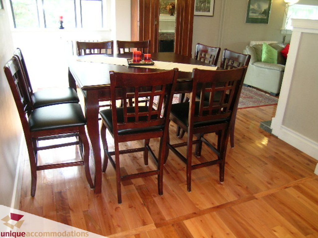 Bright dining room with wooden table, chairs, and hardwood floors. - 813 - 5th Street East, North Vancouver