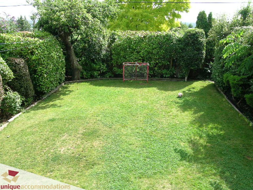 Lush backyard with soccer goal and greenery. - 813 - 5th Street East, North Vancouver