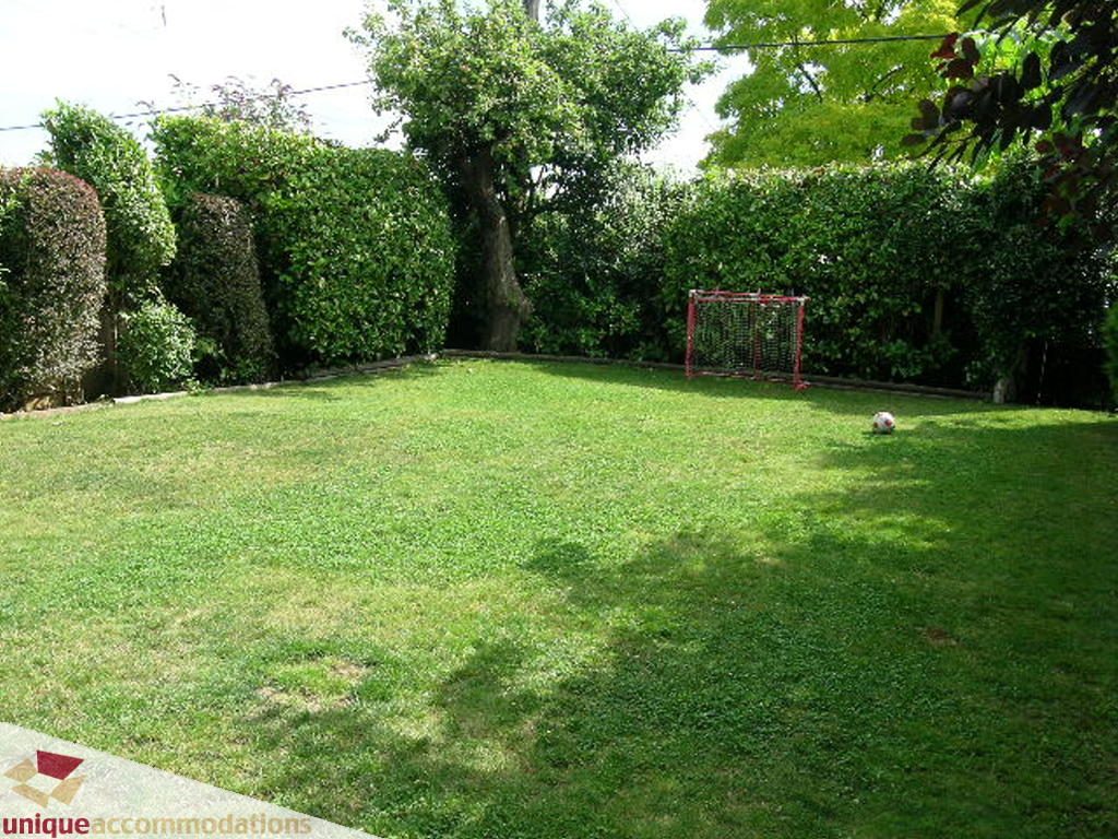 Lush backyard with soccer goal and neatly trimmed hedges. - 813 - 5th Street East, North Vancouver