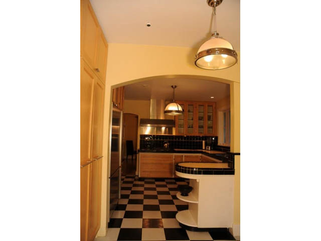 Bright kitchen with black-and-white checkered floor and modern pendant light. - 3998 West 10th Avenue, Vancouver West Side