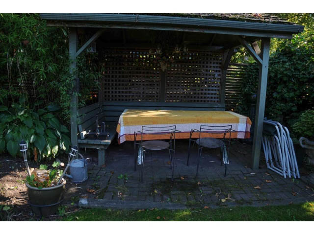 Outdoor patio with wooden furniture and lattice privacy screen. - 3998 West 10th Avenue, Vancouver West Side