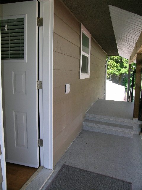 Entryway with white door, small window, and carpeted floor. - #2 (Upper) - 350 23rd St E, North Vancouver