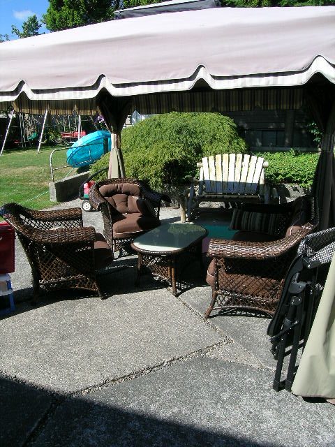 Furnished patio with wicker furniture, outdoor table, and awning. - #2 (Upper) - 350 23rd St E, North Vancouver