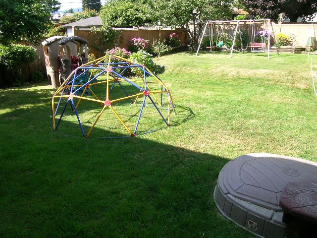 Backyard with swing set and play structure. - #2 (Upper) - 350 23rd St E, North Vancouver
