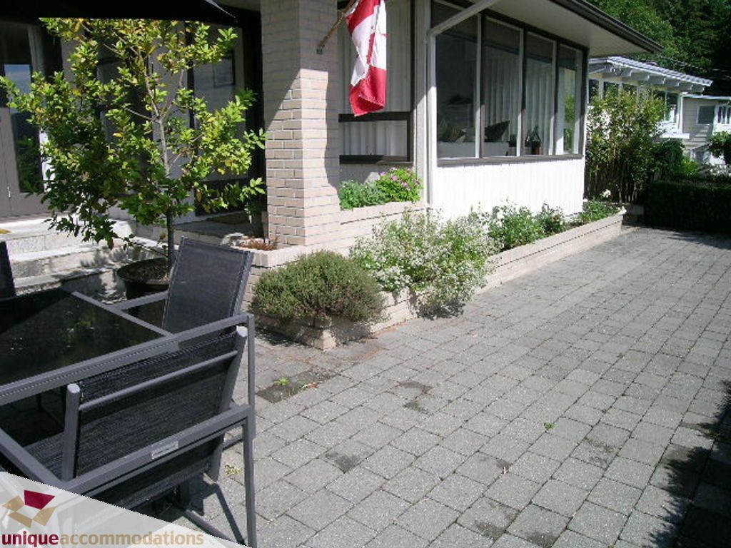 Furnished patio with outdoor furniture and garden plants. - 68 Bonnymuir Drive, West Vancouver