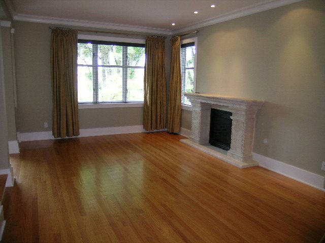 Bright living room with hardwood floors and large windows offering a city view. - 3670 Point Grey Road, Vancouver West Side