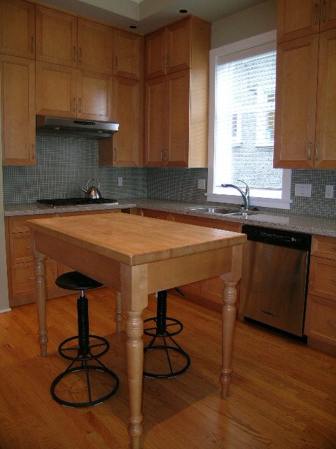 Bright kitchen with wooden island, granite countertops, hardwood floors, and a window with blinds. - 3670 Point Grey Road, Vancouver West Side