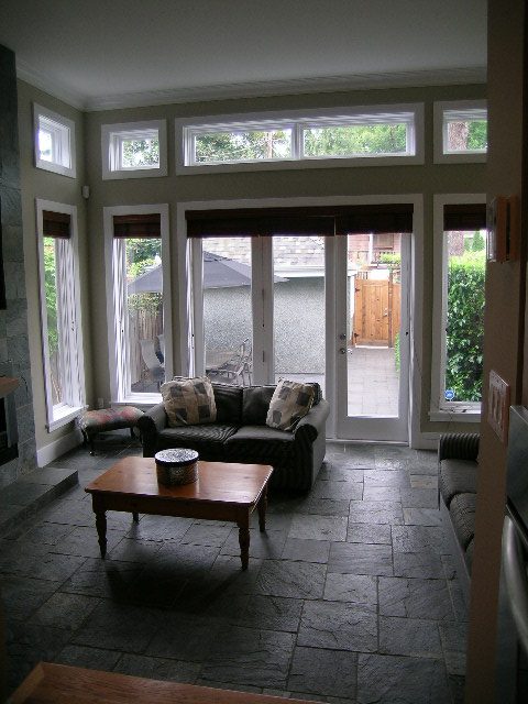 Bright sunroom with large windows, stone flooring, and outdoor patio access. - 3670 Point Grey Road, Vancouver West Side