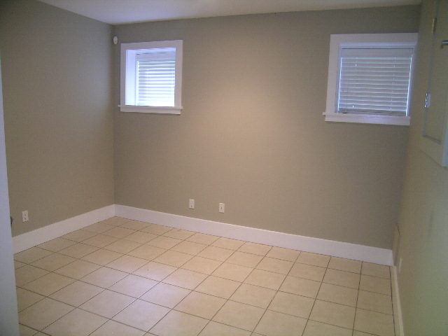 Bright laundry room with tiled floor and built-in shelving. - 3670 Point Grey Road, Vancouver West Side
