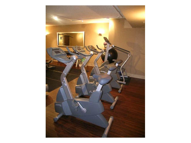Bright gym with exercise bikes and mirrors. - 614 - 610 Granville St, Vancouver Downtown