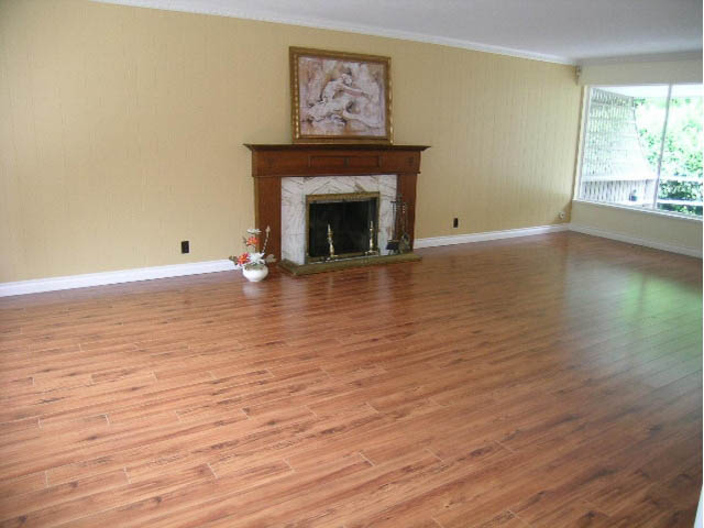 Living room with hardwood floors, fireplace, and large windows. - 5725 Cranley Drive, West Vancouver