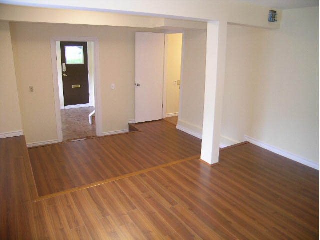 Bright living room with hardwood floors and open door leading to another room. - 5725 Cranley Drive, West Vancouver