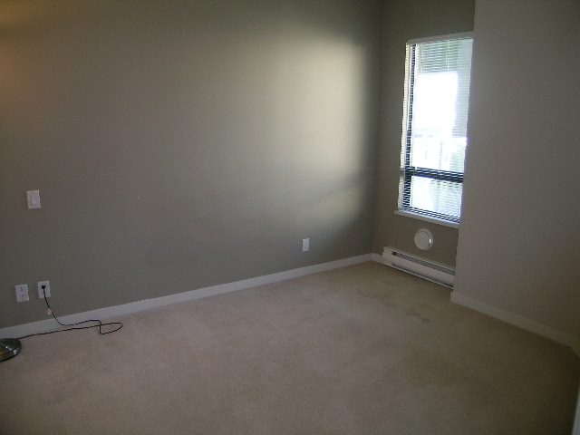 Bright living room with carpeted floor and large window. - 305 - 2228 Marstrand Avenue, Vancouver West Side