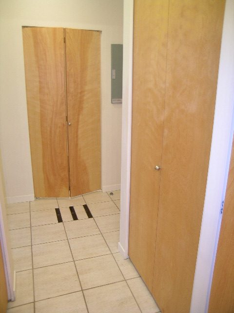Bright hallway with wooden doors and tiled floor. - 305 - 2228 Marstrand Avenue, Vancouver West Side