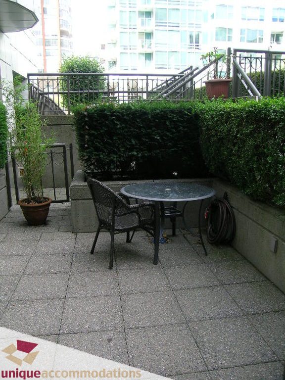 Furnished patio with table, chairs, and potted plants. - T15 - 1501 Howe Street, Vancouver Downtown