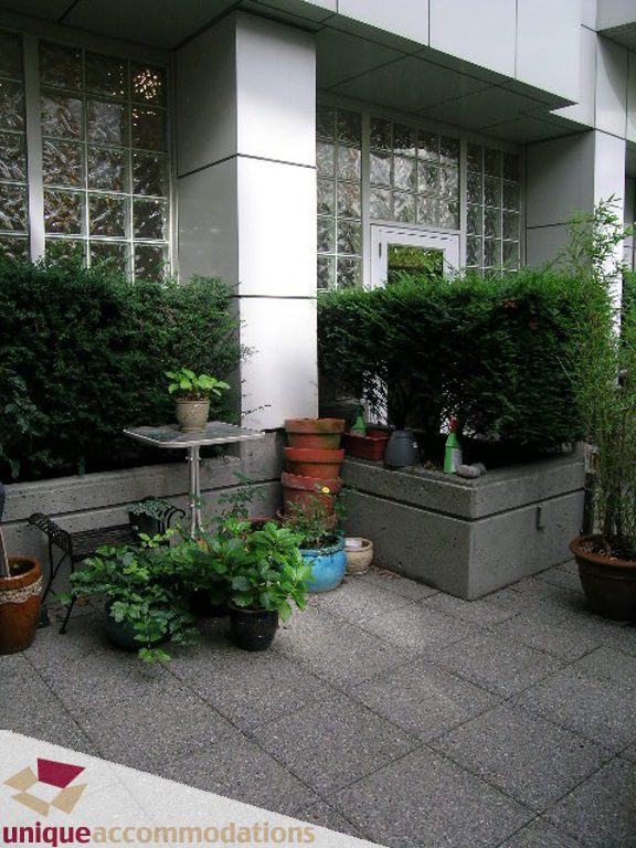 Furnished patio with potted plants and stacked terracotta pots. - T15 - 1501 Howe Street, Vancouver Downtown