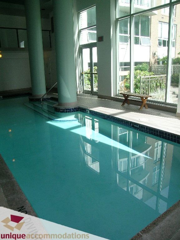 Spacious indoor pool with large windows and city view. - T15 - 1501 Howe Street, Vancouver Downtown
