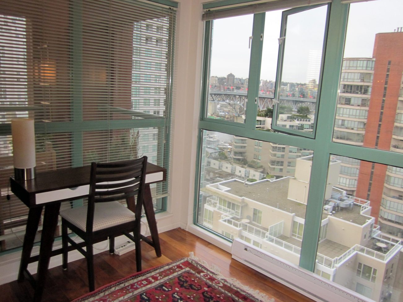 Bright dining area with hardwood floors and a stunning city view. - 1403 - 907 Beach Avenue, Vancouver Downtown