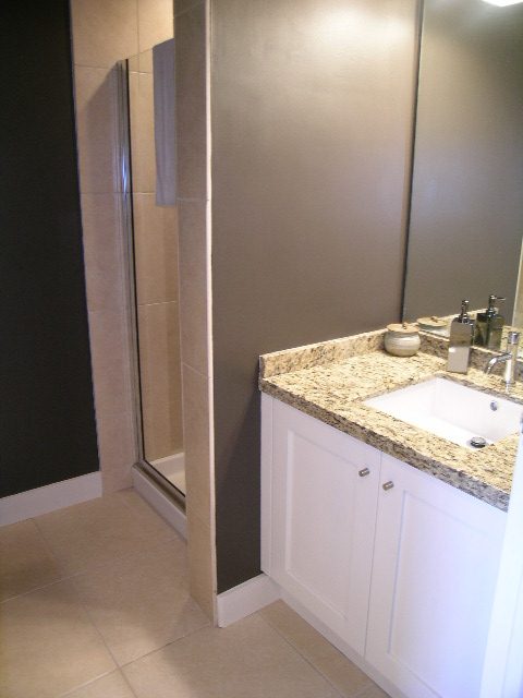 Furnished bathroom with granite countertops and white cabinetry. - 902 - 1625 Hornby Street, Vancouver Downtown