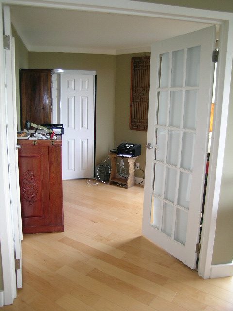 Bright kitchen with hardwood floors and a countertop, leading to a den area. - 902 - 1625 Hornby Street, Vancouver Downtown