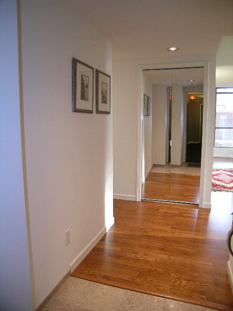Bright living room with hardwood floors and framed artwork on the wall. - 1701 - 867 Hamilton Street, Vancouver Downtown